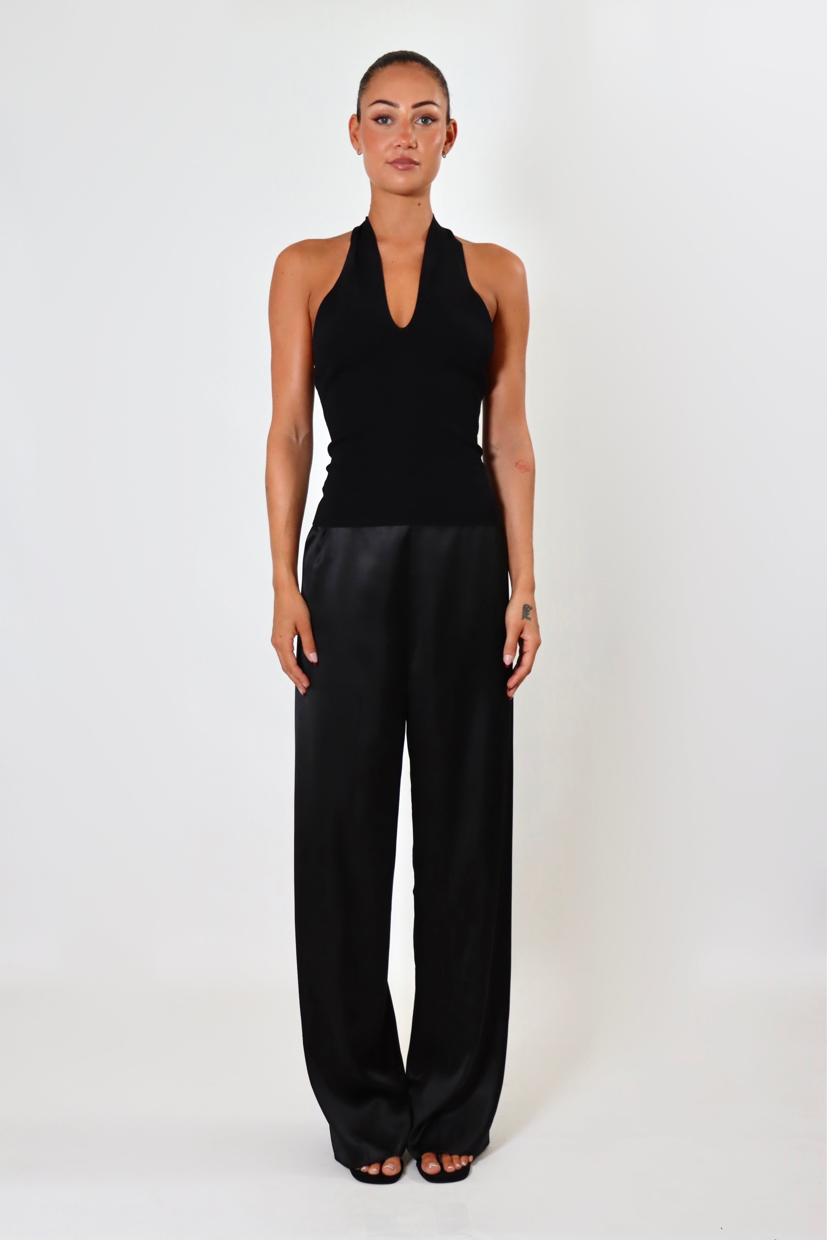 April Satin Pant Tall in black – mid-rise satin pant with extended length and elastic waistband.