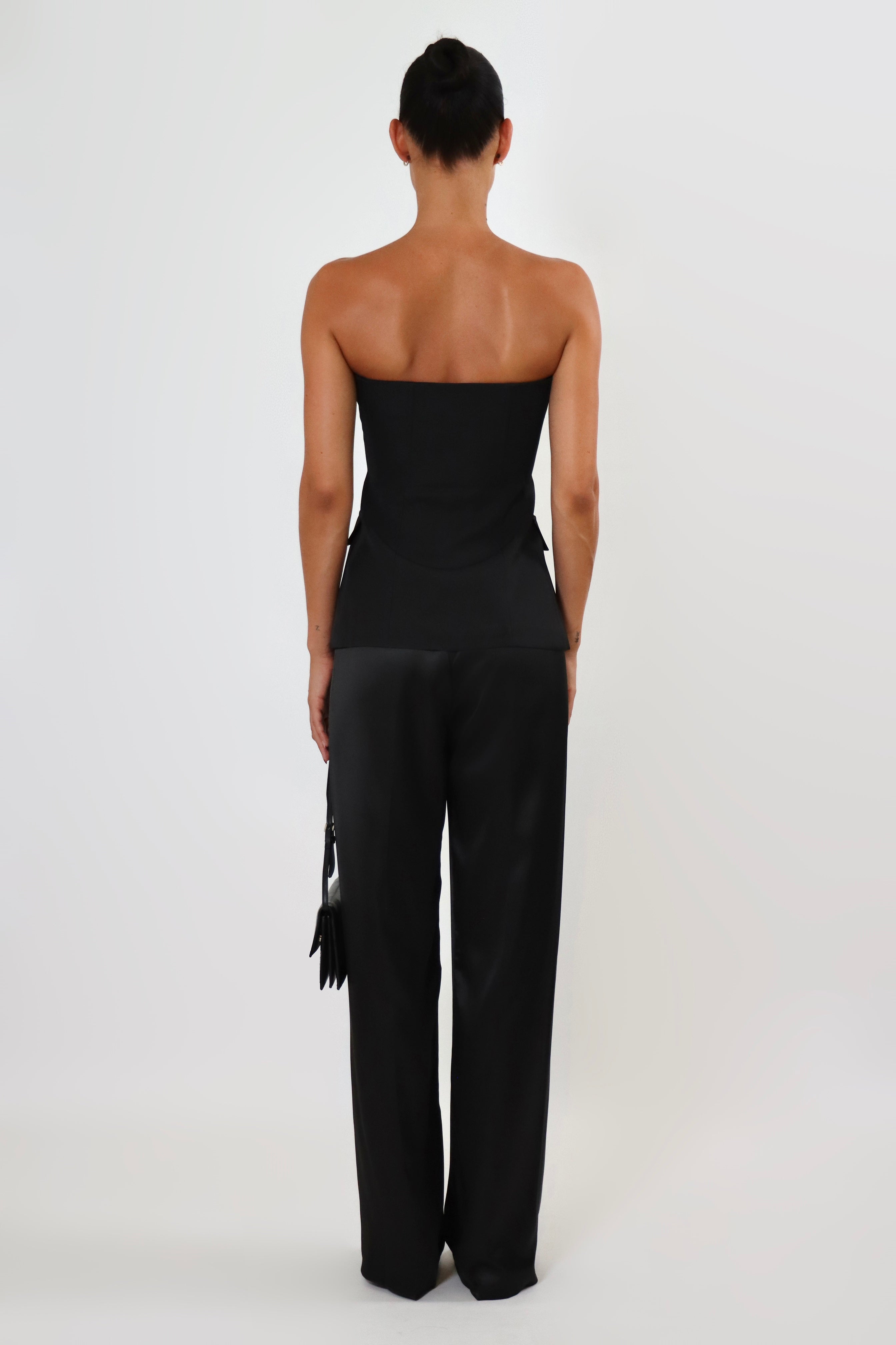 April Seven strapless vest top in black – structured strapless silhouette with button closure and flap pockets.