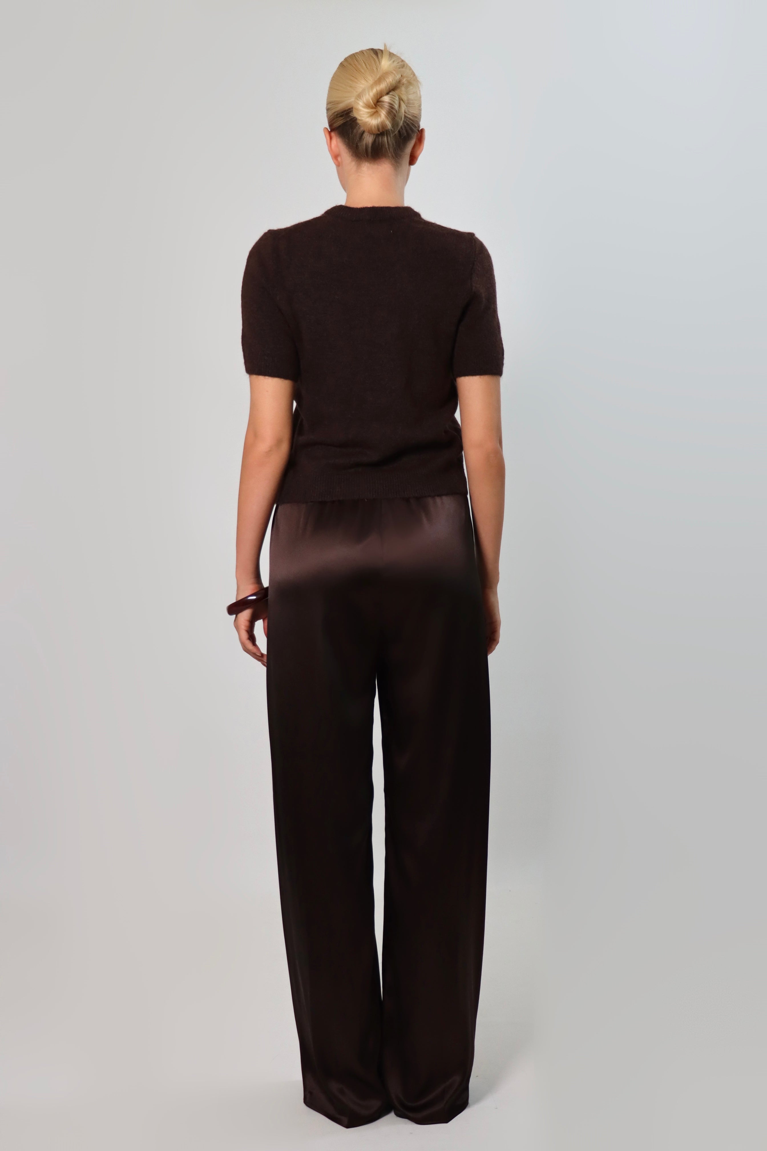 Elegant mid-waist wide-leg satin pants in a rich espresso brown shade, featuring a smooth, glossy finish and a fluid drape for a sophisticated, effortless look.