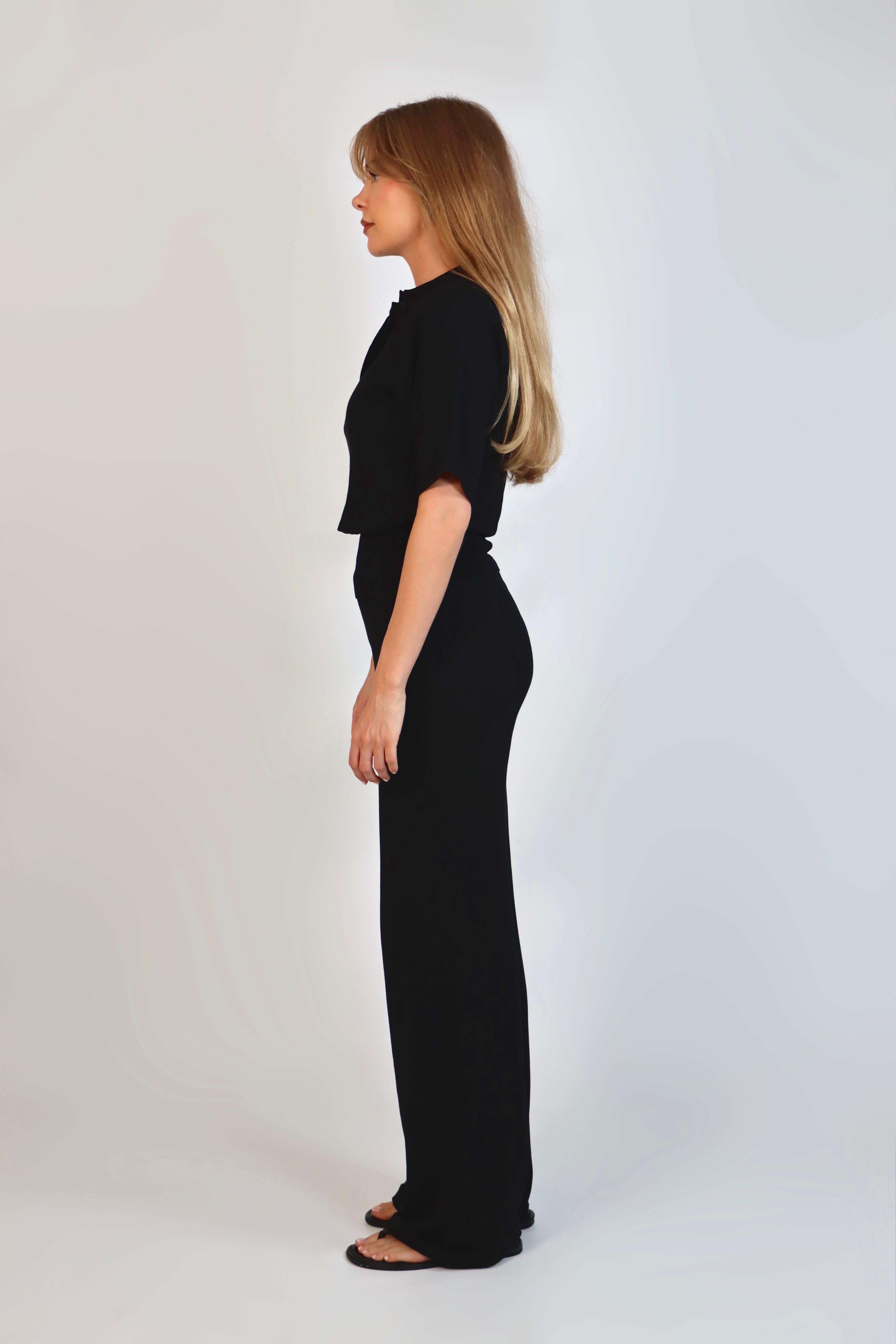 Black fine knit pants with a relaxed fit and soft stretch, women’s chic comfortable knit trousers.