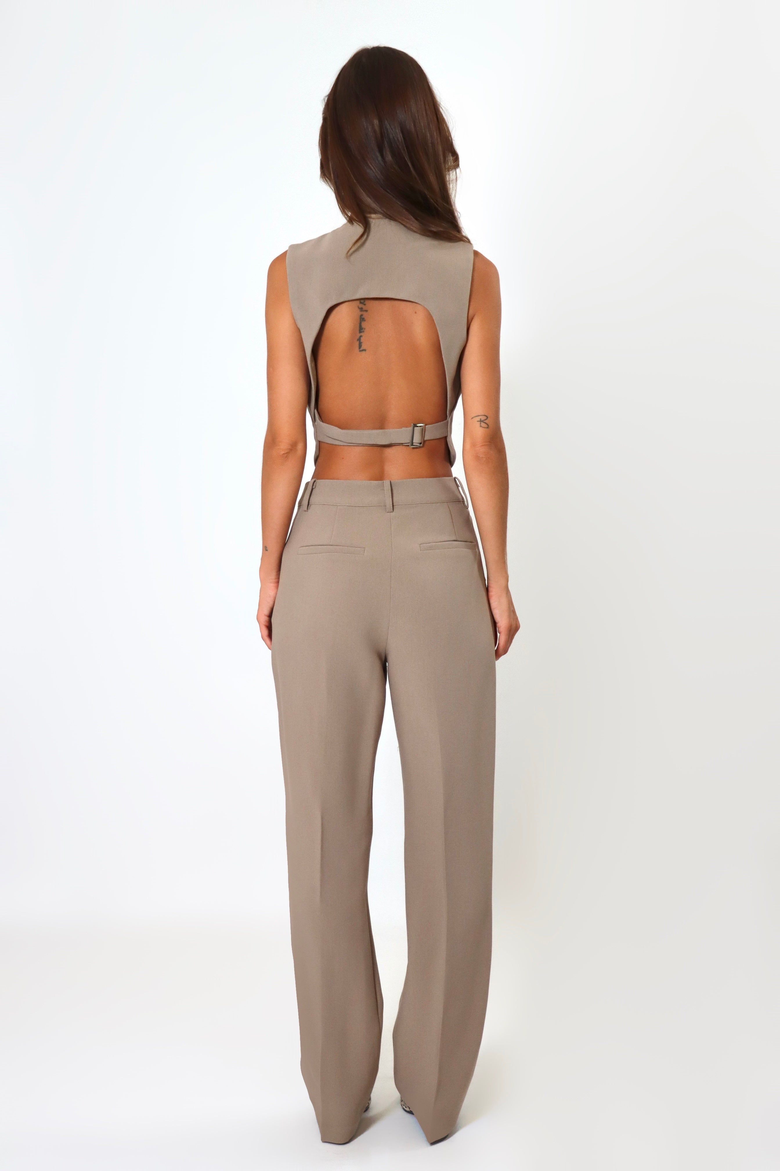 April Seven cropped backless vest and straight-leg pant set in mocha – neutral tailored two-piece with cropped vest and mid-waist trousers.