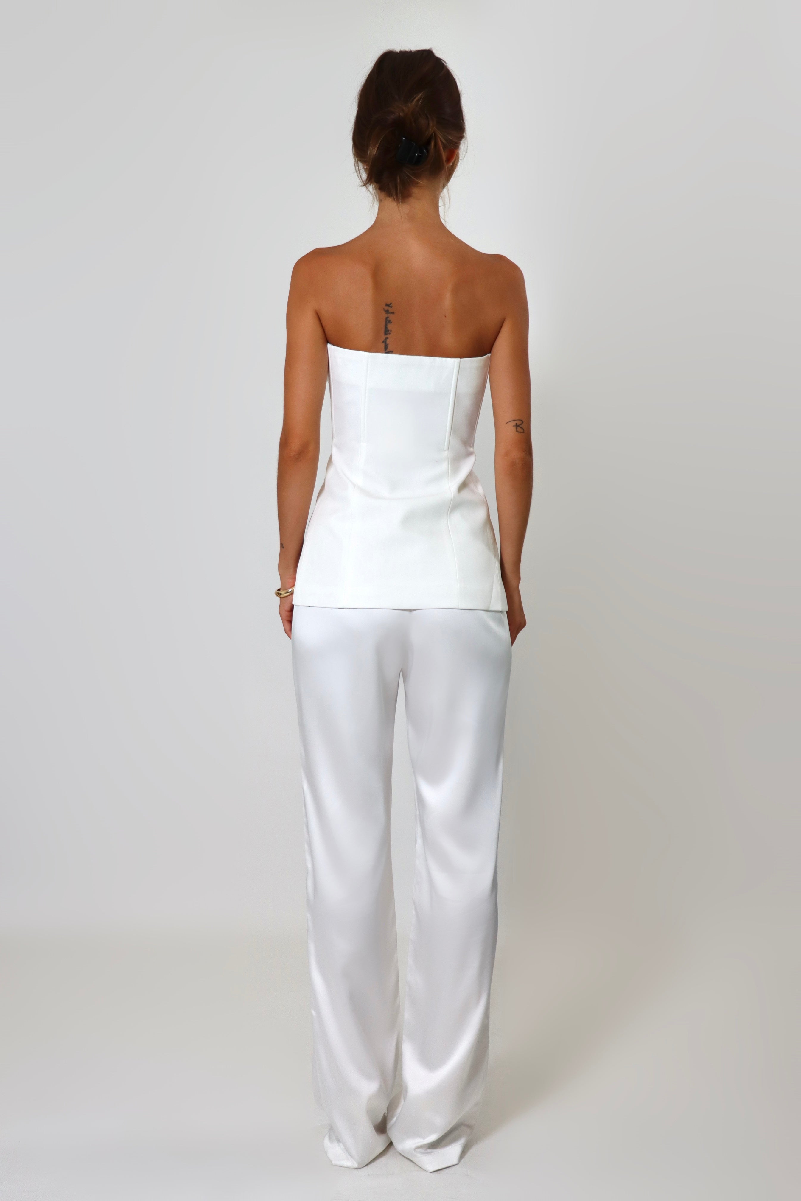 April Seven strapless vest top in white – tailored design with button-up front and flap pockets.