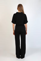Black fine knit pants with a relaxed fit and soft stretch, women’s chic comfortable knit trousers.