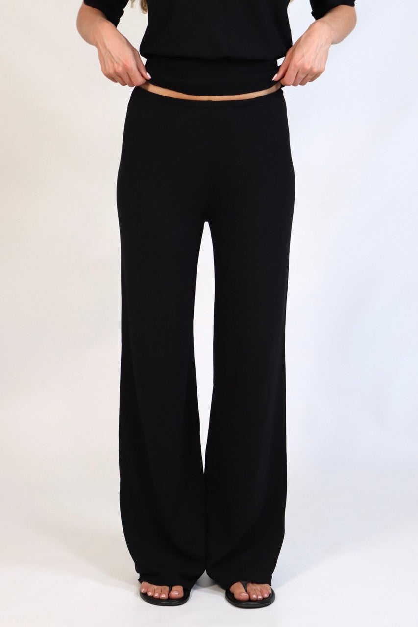 Black fine knit pants with a relaxed fit and soft stretch, women’s chic comfortable knit trousers.