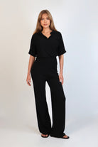 Black fine knit pants with a relaxed fit and soft stretch, women’s chic comfortable knit trousers.