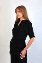 Black fine knit polo top paired with matching fine knit pants for an elevated knit set.