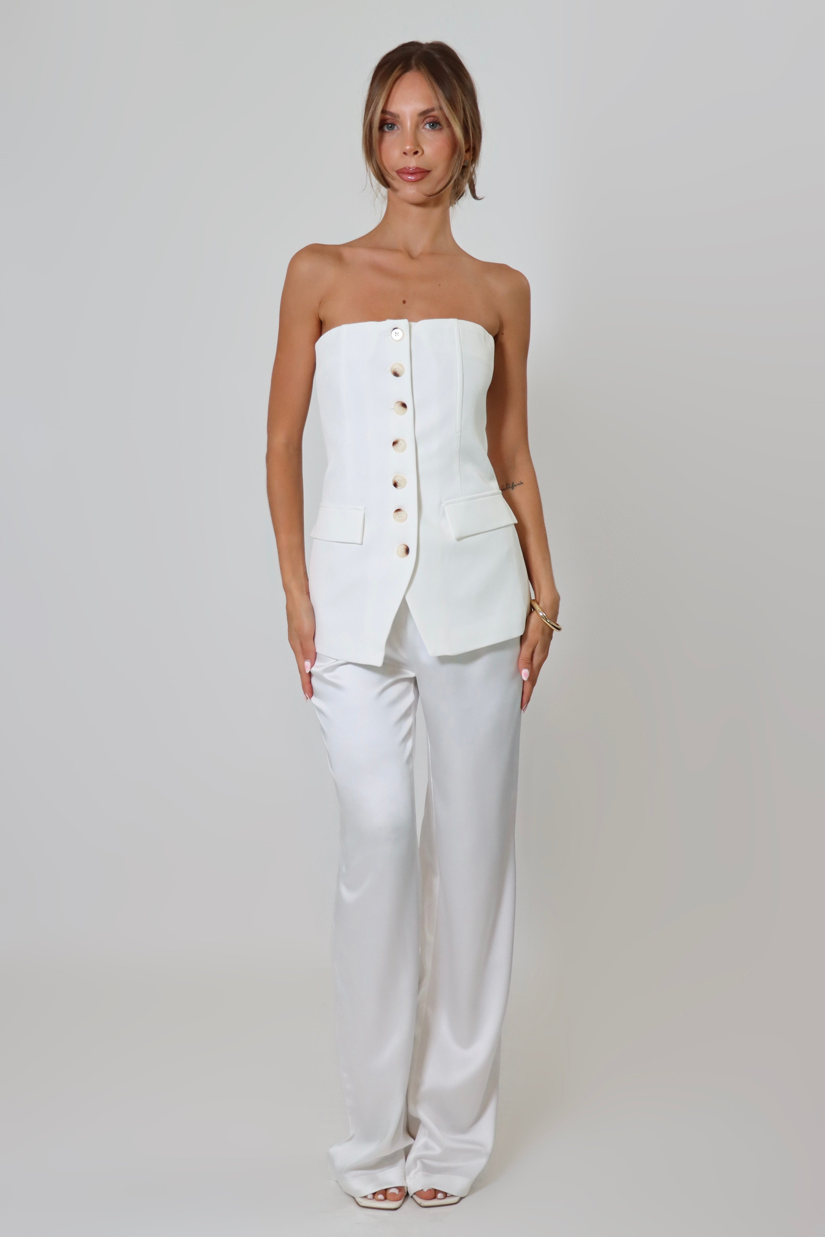 April Seven strapless vest top in white – tailored design with button-up front and flap pockets.